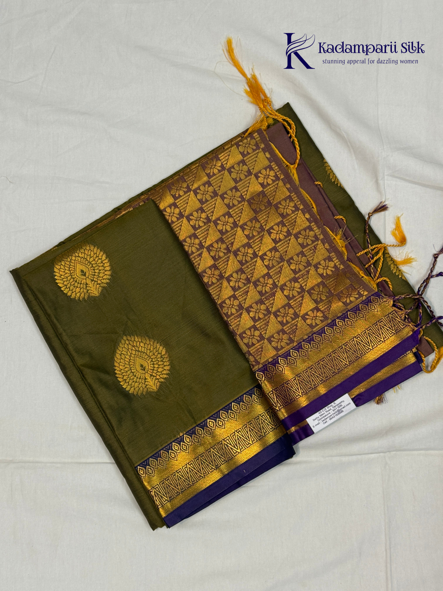 Kadamparii Silk olive green semi soft silk saree with gold zari peacock motifs, rich purple woven pallu, intricate zari border, and tassel detailing.