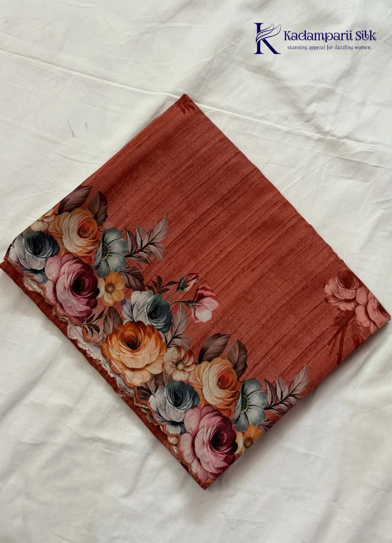 Kadamparii Silk rust orange tussar saree with digital body and multicolour floral border, displayed on a white background.