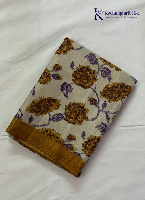 Kadamparii Silk cream semi tussar silk saree with mustard purple floral print and mustard border, displayed on a white background.