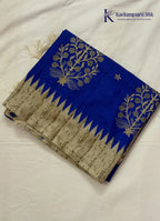 Kadamparii Silk royal blue tussar cutwork saree with floral motifs and contrasting beige cutwork border, displayed on a white background.