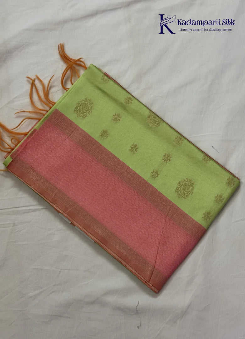 Kadamparii Silk light green raw silk saree with peach zari border and elegant butta detailing, displayed on a white background.
