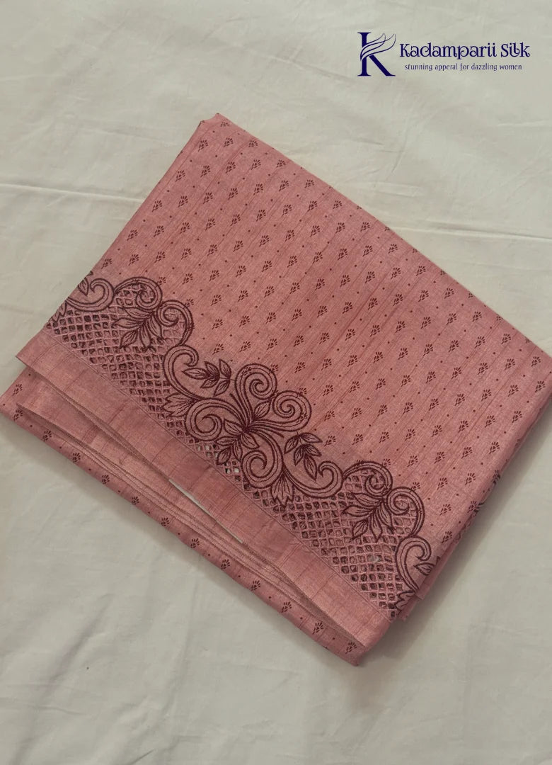 Kadamparii Silk dusty pink raw silk saree with embroidery work, subtle body motifs, and decorative border, displayed on a white background.