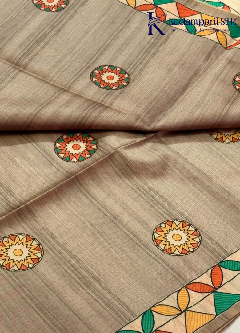 Kadamparii Silk taupe grey semi tussar silk saree with artistic printed mundhi, floral leaf motifs, and multicolour border, displayed on a white background.