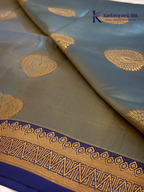 Kadamparii Silk teal blue semi soft silk saree with gold zari motifs, rich purple checkered zari pallu, ornate woven border, royal blue accents, and tassel detailing.