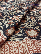 Black Jaipur cotton saree with floral Kalamkari print and traditional printed border by Kadamparii Silk.