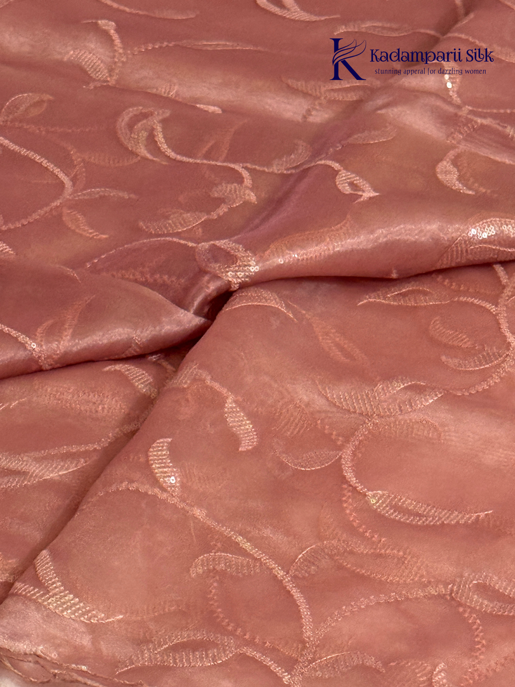 Rose pink shimmer silk saree with elegant sequin embroidery, soft shimmer texture, scalloped border detailing, lightweight flowy fabric, and glamorous partywear styling by Kadamparii Silk.