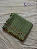Sage green Tussar silk saree with embroidered peacock and floral border, subtle zari detailing, textured lightweight fabric, tassel finish, and elegant traditional styling by Kadamparii Silk.
