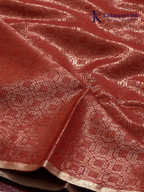 Rose pink semi Tussar jacquard saree with all-over woven geometric patterns, subtle silver zari detailing, soft textured finish, elegant tassels, and lightweight traditional drape by Kadamparii Silk.