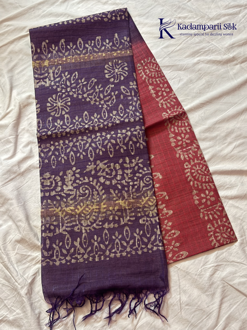 Blush pink semi tussar saree with traditional batik print and purple contrast pallu by Kadamparii Silk.