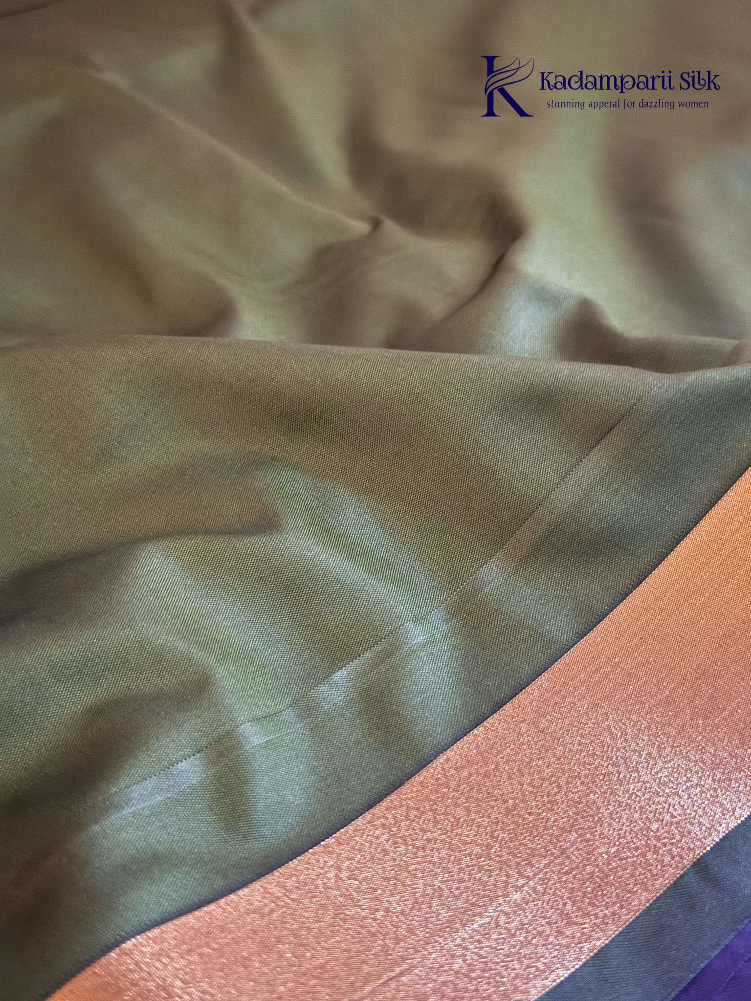 Kadamparii Silk royal purple semi soft silk saree with olive green zari woven pallu, intricate checkered motifs, copper gold zari border, geometric zari designs, and tassel detailing.