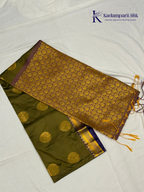 Kadamparii Silk olive green semi soft silk saree with gold zari peacock motifs, rich purple woven pallu, intricate zari border, and tassel detailing.