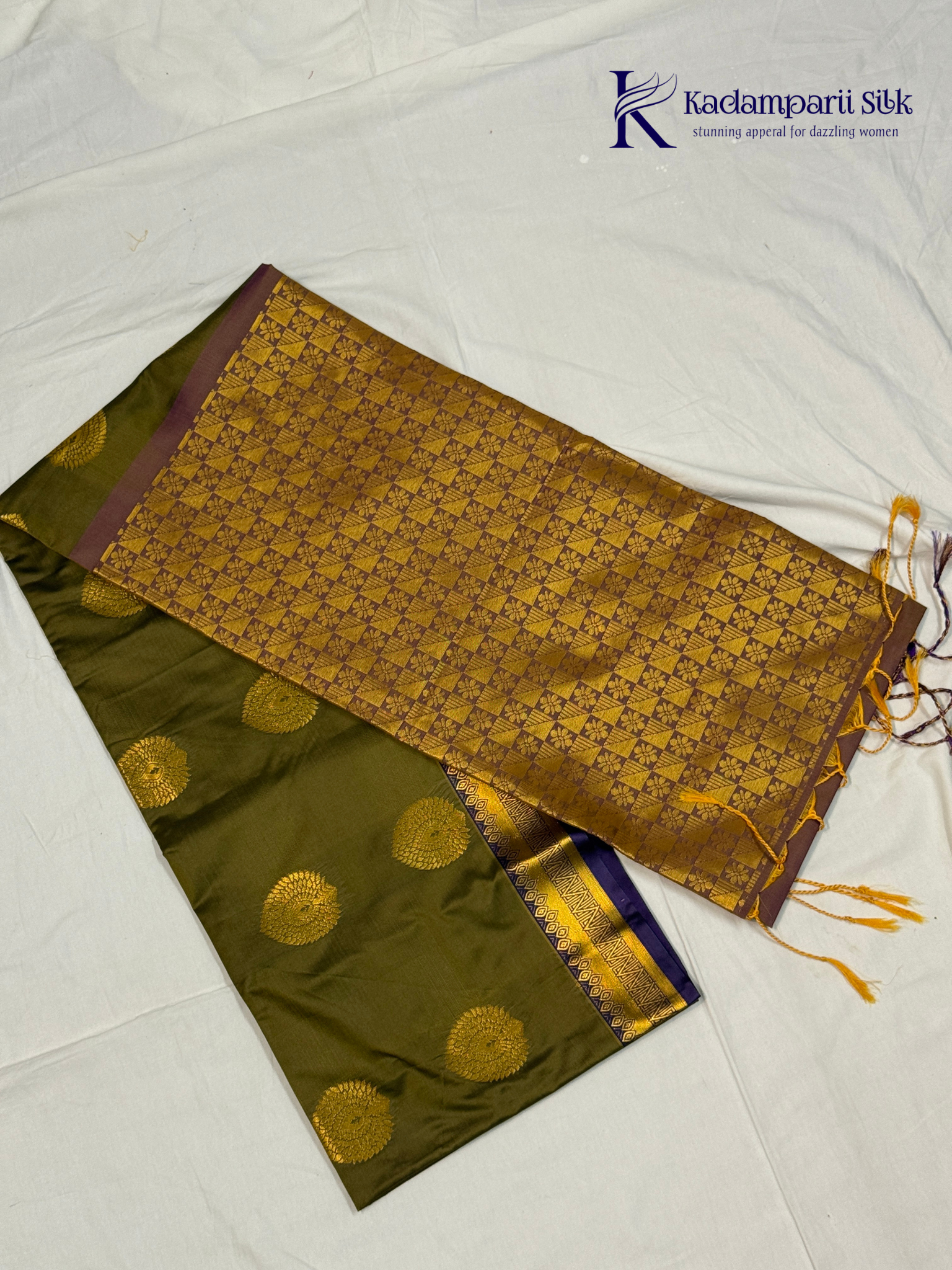 Kadamparii Silk olive green semi soft silk saree with gold zari peacock motifs, rich purple woven pallu, intricate zari border, and tassel detailing.