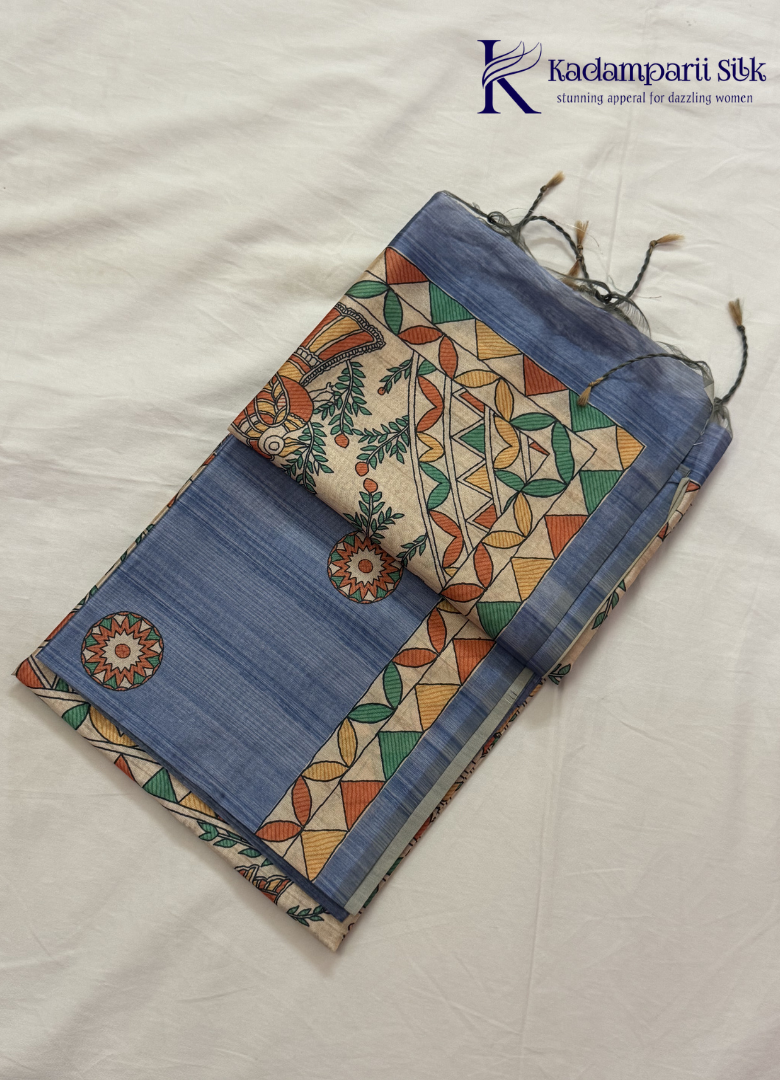 Kadamparii Silk dusty blue semi tussar silk saree with floral printed mundhi and multicolour border, displayed on a white background.