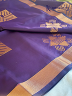Kadamparii Silk royal purple semi soft silk saree with olive green zari woven pallu, intricate checkered motifs, copper gold zari border, geometric zari designs, and tassel detailing.
