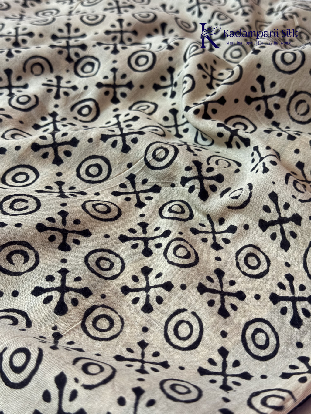Black Jaipur cotton saree with floral Kalamkari print and traditional printed border by Kadamparii Silk.