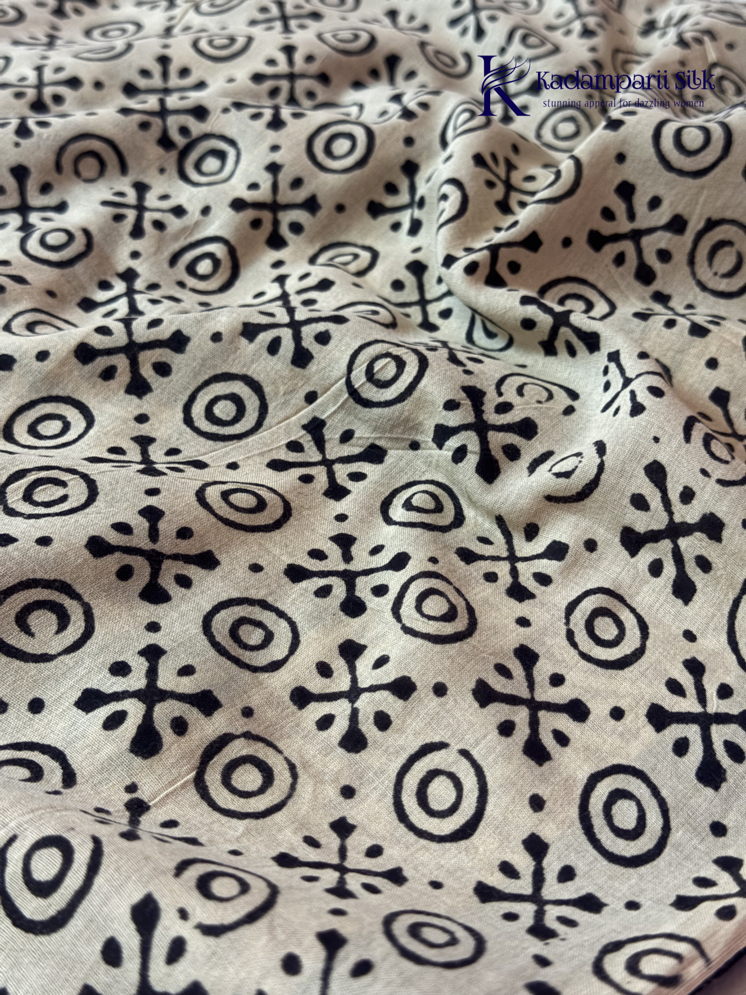 Black Jaipur cotton saree with floral Kalamkari print and traditional printed border by Kadamparii Silk.