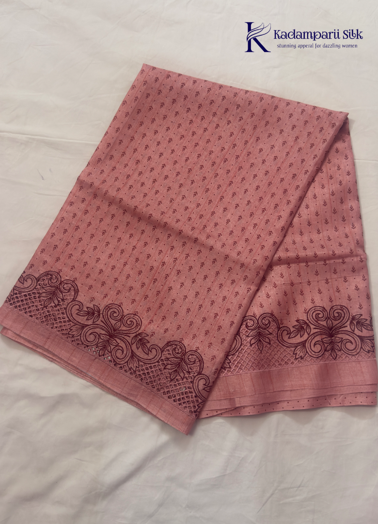 Kadamparii Silk dusty pink raw silk saree with embroidery work, subtle body motifs, and decorative border, displayed on a white background.
