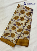 Kadamparii Silk cream semi tussar silk saree with mustard purple floral print and mustard border, displayed on a white background.