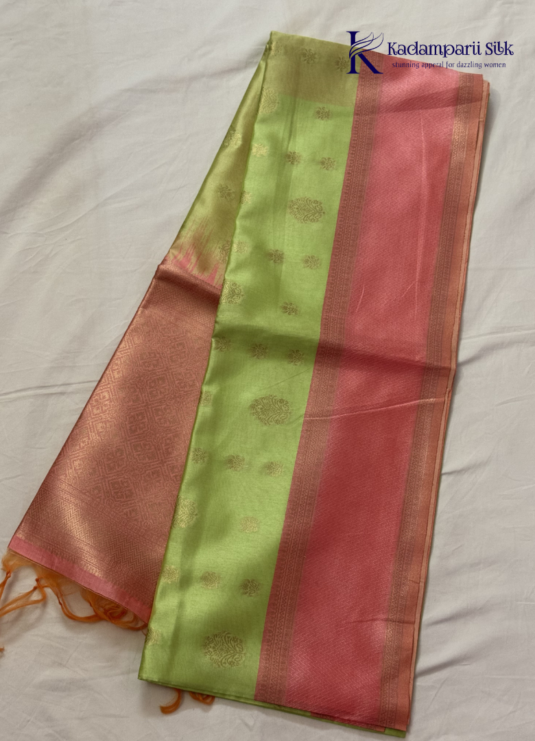 Kadamparii Silk light green raw silk saree with peach zari border and elegant butta detailing, displayed on a white background.