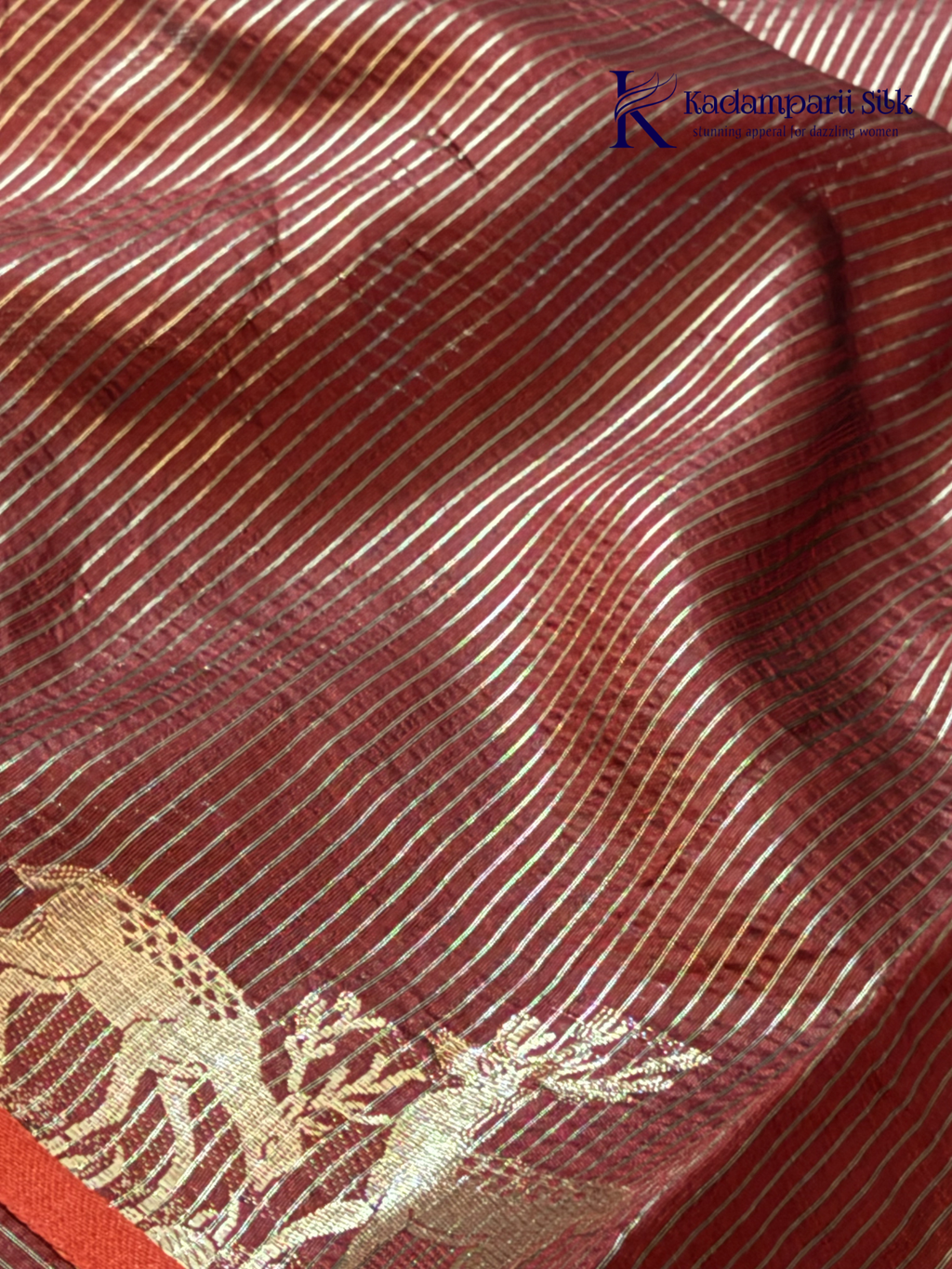 Black semi raw silk saree with red butta motifs, elegant zari woven border and pallu, soft lightweight texture, tassel detailing, and traditional ethnic styling by Kadamparii Silk.