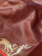 Black semi raw silk saree with red butta motifs, elegant zari woven border and pallu, soft lightweight texture, tassel detailing, and traditional ethnic styling by Kadamparii Silk.