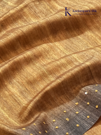 Grey Chenderi silk cotton saree with elegant floral vine design, intricate French knot work, copper-toned border and pallu, soft lightweight fabric, tassel detailing, and graceful ethnic styling by Kadamparii Silk.