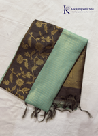 Kadamparii Silk mint green raw silk saree with floral zari border and subtle zari detailing, displayed on a white background.