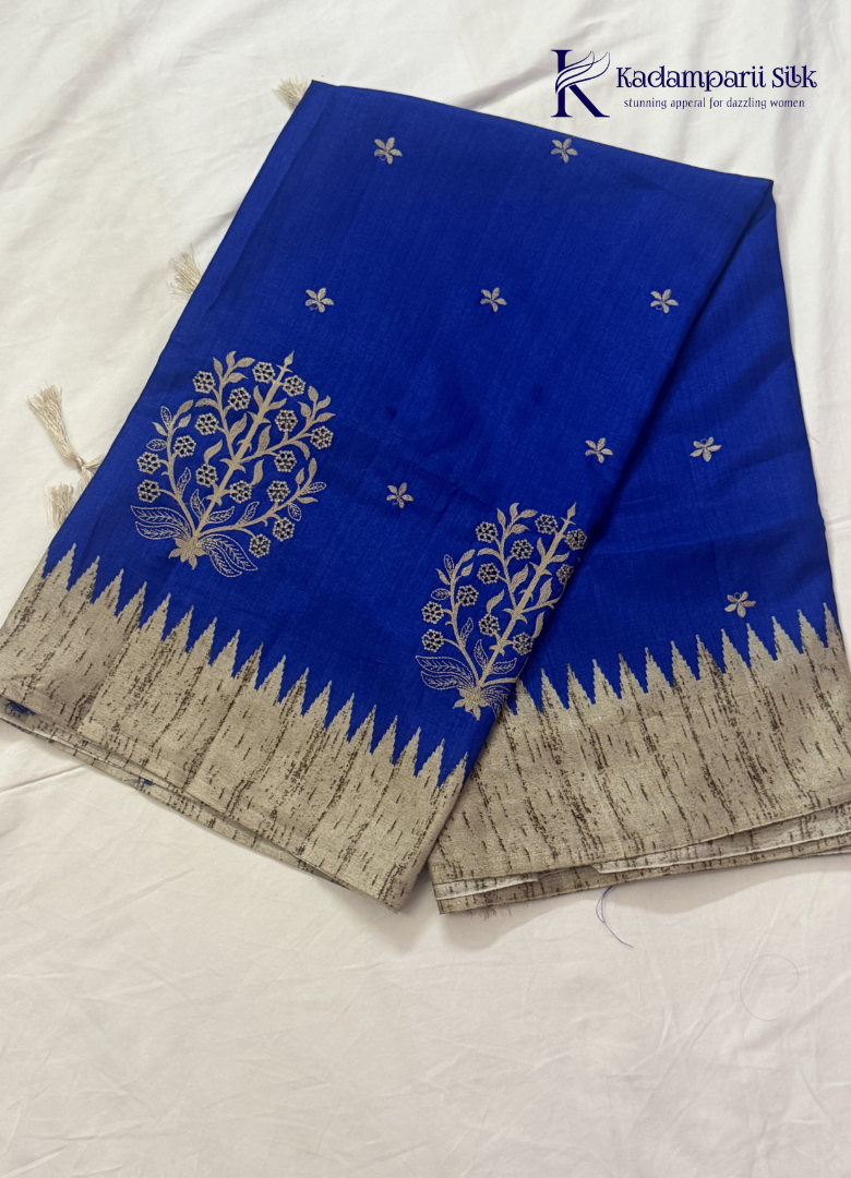Kadamparii Silk royal blue tussar cutwork saree with floral motifs and contrasting beige cutwork border, displayed on a white background.