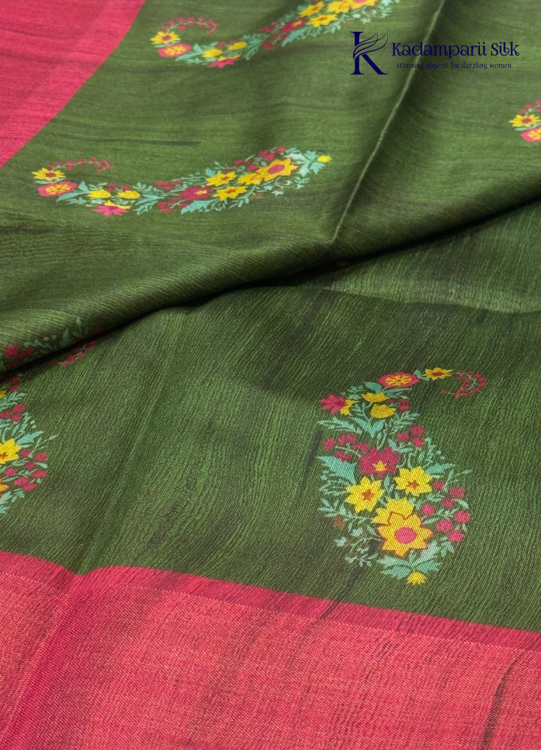 Adorn yourself in this Soft Tussar Silk Saree, featuring a graceful olive green body embellished with delicate floral buttas and finished with a striking rose pink contrast border. Lightweight, elegant, and effortlessly stylish—perfect for every special occasion.