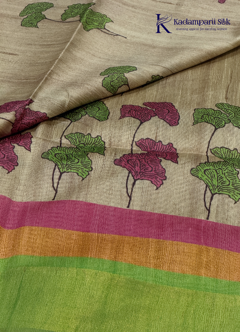Drape yourself in this Soft Tussar Silk Saree, featuring a graceful botanical leaf print on a subtle beige body, complemented by a vibrant multicolor contrast border. Lightweight, elegant, and effortlessly stylish—perfect for every occasion.