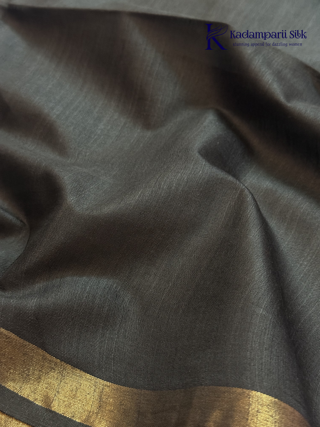 Black semi tussar saree with floral digital print and subtle golden zari border by Kadamparii Silk.