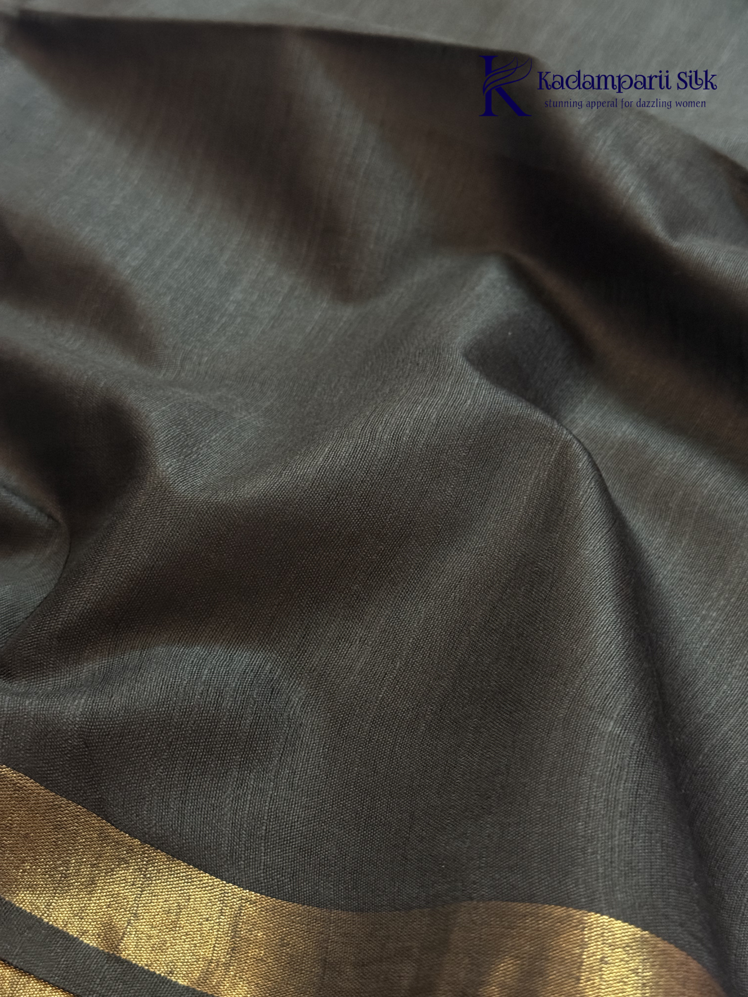 Black semi tussar saree with floral digital print and subtle golden zari border by Kadamparii Silk.