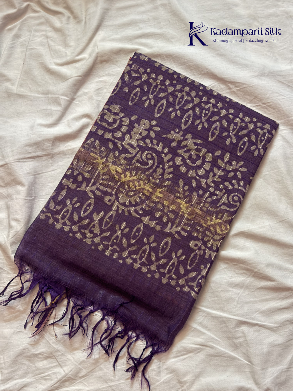 Blush pink semi tussar saree with traditional batik print and purple contrast pallu by Kadamparii Silk.