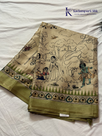 Soft Tussar saree with traditional pencil art print featuring mythological village scene motifs, subtle olive green zari border, artistic hand-drawn style detailing, and elegant lightweight drape by Kadamparii Silk.