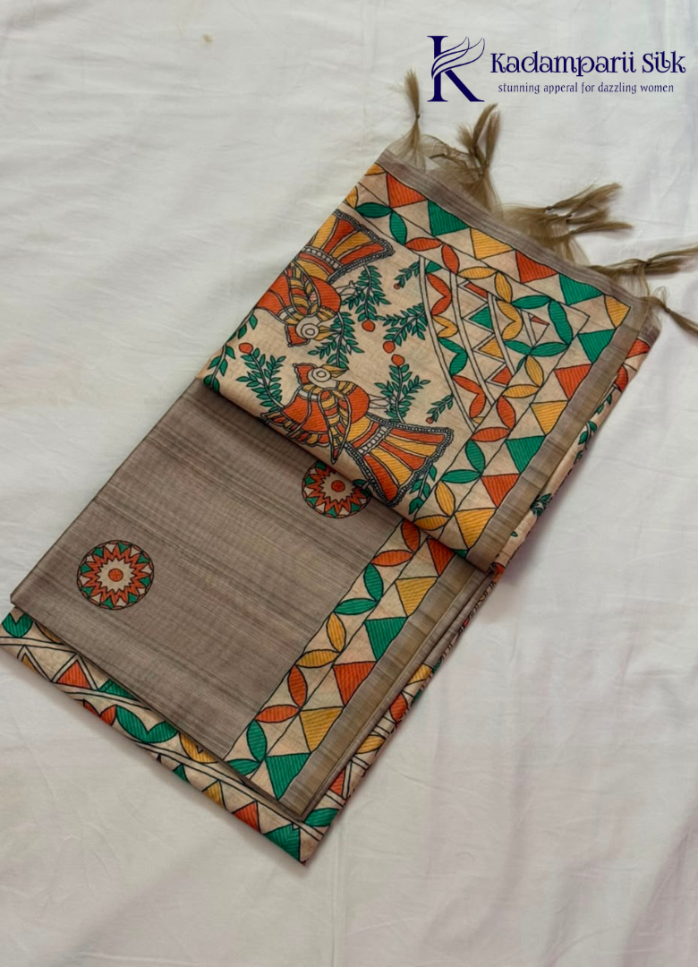 Kadamparii Silk taupe grey semi tussar silk saree with artistic printed mundhi, floral leaf motifs, and multicolour border, displayed on a white background.