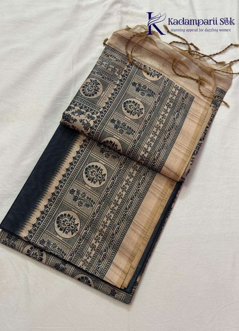 Kadamparii Silk black semi tussar silk saree with traditional printed mundhi and beige border, displayed on a white background.