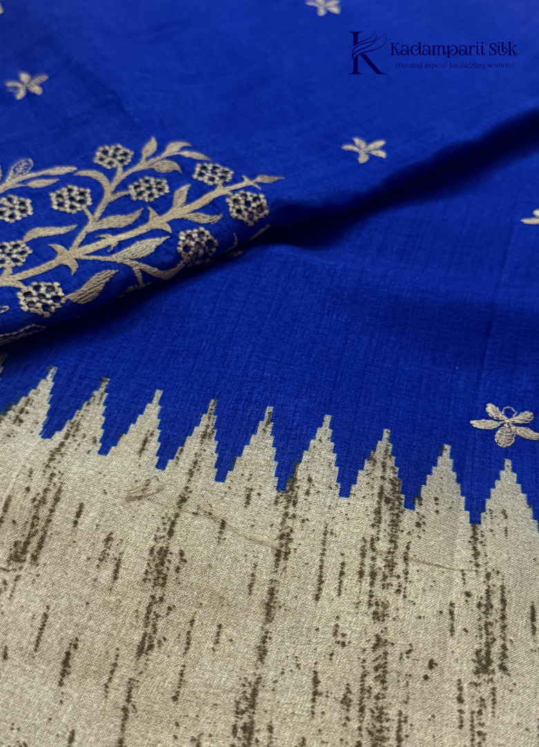 Kadamparii Silk royal blue tussar cutwork saree with floral motifs and contrasting beige cutwork border, displayed on a white background.