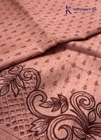 Kadamparii Silk dusty pink raw silk saree with embroidery work, subtle body motifs, and decorative border, displayed on a white background.