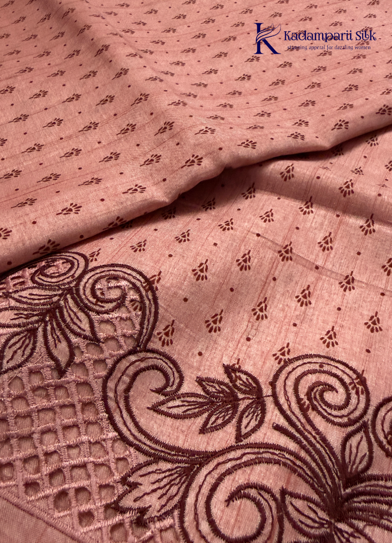 Kadamparii Silk dusty pink raw silk saree with embroidery work, subtle body motifs, and decorative border, displayed on a white background.