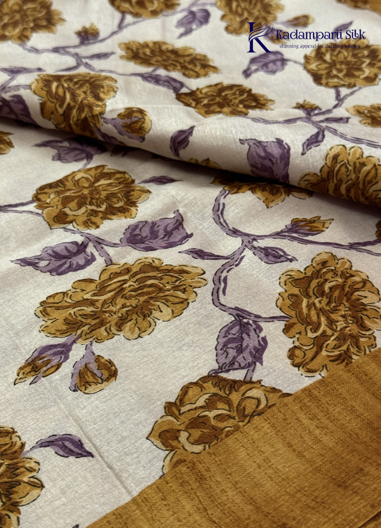 Kadamparii Silk cream semi tussar silk saree with mustard purple floral print and mustard border, displayed on a white background.
