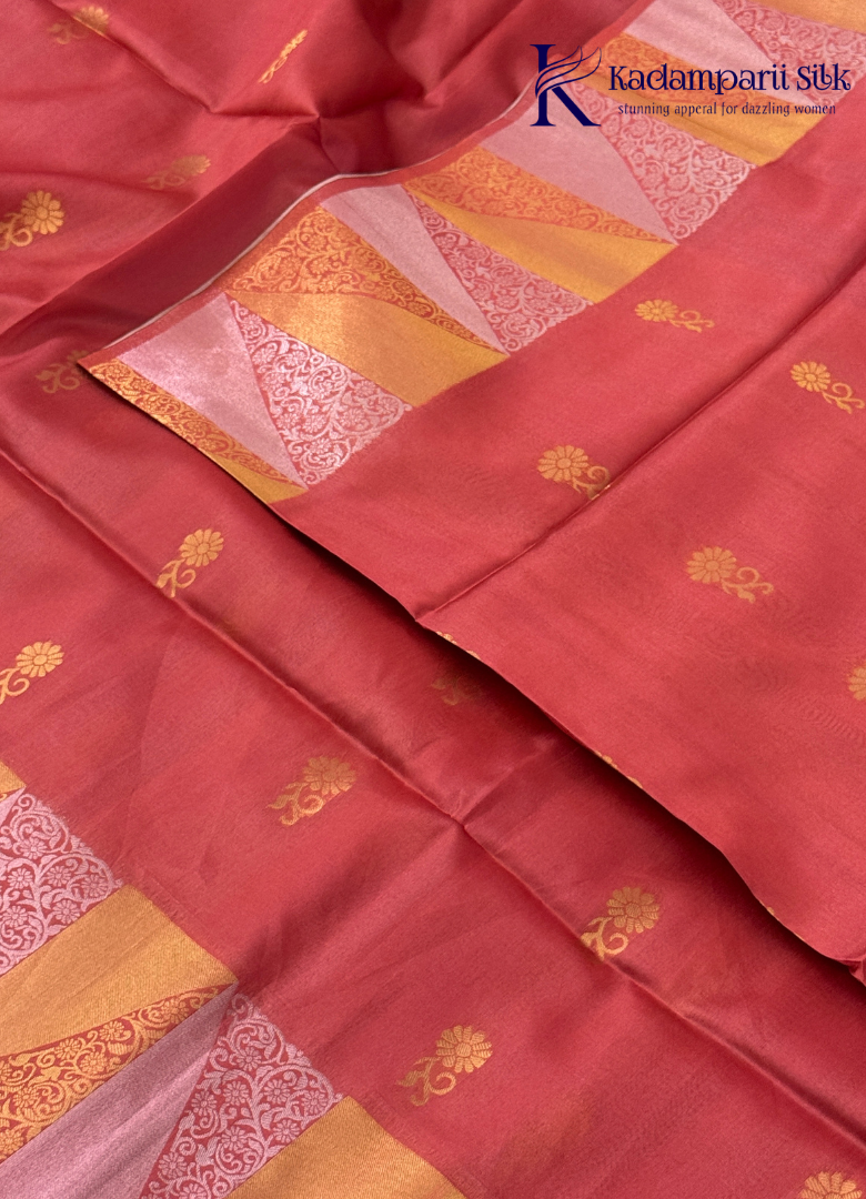 Kadamparii Silk pink semi raw silk saree with zari work and copper patterned border, folded on a light background.