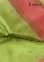 Kadamparii Silk light green raw silk saree with peach zari border and elegant butta detailing, displayed on a white background.
