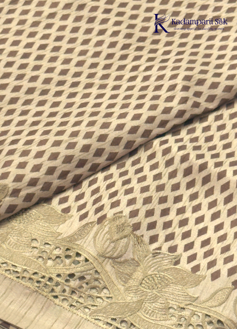 Kadamparii Silk beige tussar silk saree with woven body pattern and detailed cutwork border, displayed on a white background.