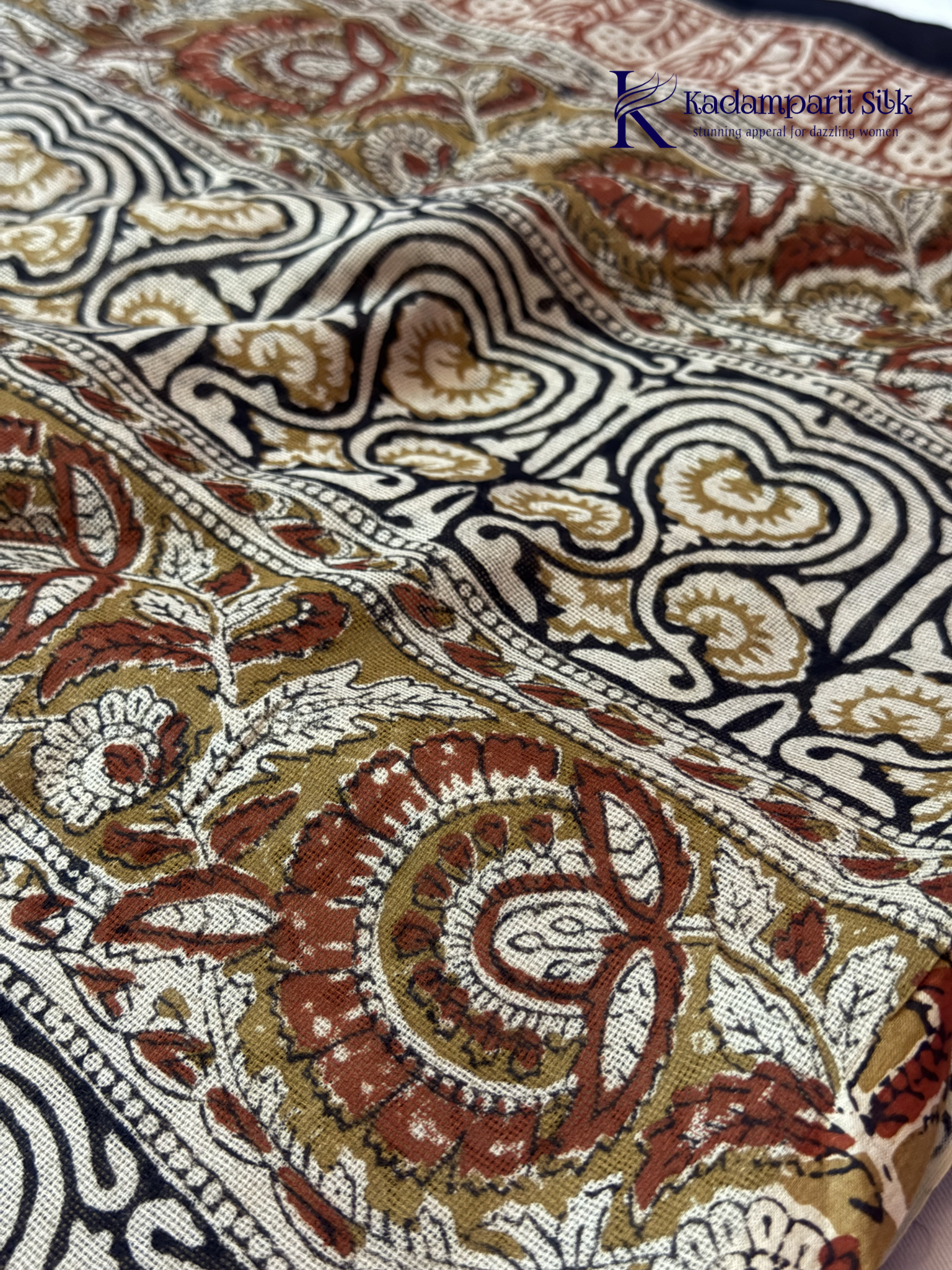 Black Jaipur cotton saree with floral Kalamkari print and traditional printed border by Kadamparii Silk.