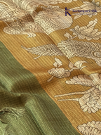 Mustard kota silk saree with floral Kalamkari print and contrast border by Kadamparii Silk.