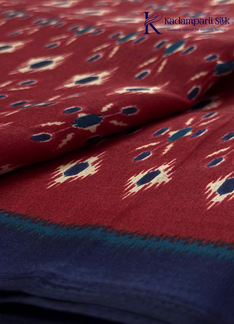 Kadamparii Silk maroon soft semi tussar silk saree with woven pattern and navy blue contrast border, displayed on a white background.