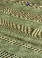 Kadamparii Silk olive green soft tussar silk saree with textured woven body and silver zari border, displayed on a white background.