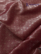 Rose pink semi Tussar jacquard saree with all-over woven geometric patterns, subtle silver zari detailing, soft textured finish, elegant tassels, and lightweight traditional drape by Kadamparii Silk.