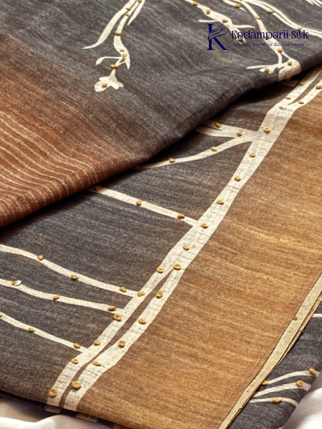 Grey Chenderi silk cotton saree with elegant floral vine design, intricate French knot work, copper-toned border and pallu, soft lightweight fabric, tassel detailing, and graceful ethnic styling by Kadamparii Silk.