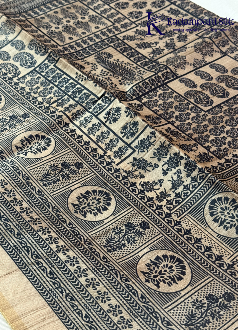 Kadamparii Silk black semi tussar silk saree with traditional printed mundhi and beige border, displayed on a white background.